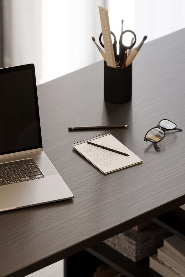 Minimal creative desk with notebook, pen, and soft natural light
